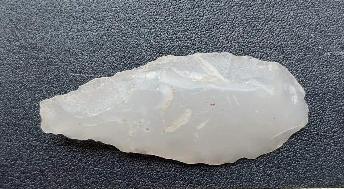 A bifacially crafted arrowhead made of white quartzite