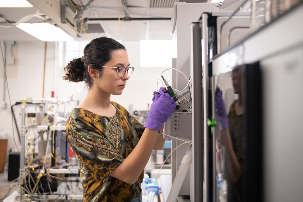 Caltech graduate student Hannah Dion- Kirschner studies microbes—tiny organisms that can typically only be seen under a microscope—in soil that eat methane, a powerful greenhouse gas.